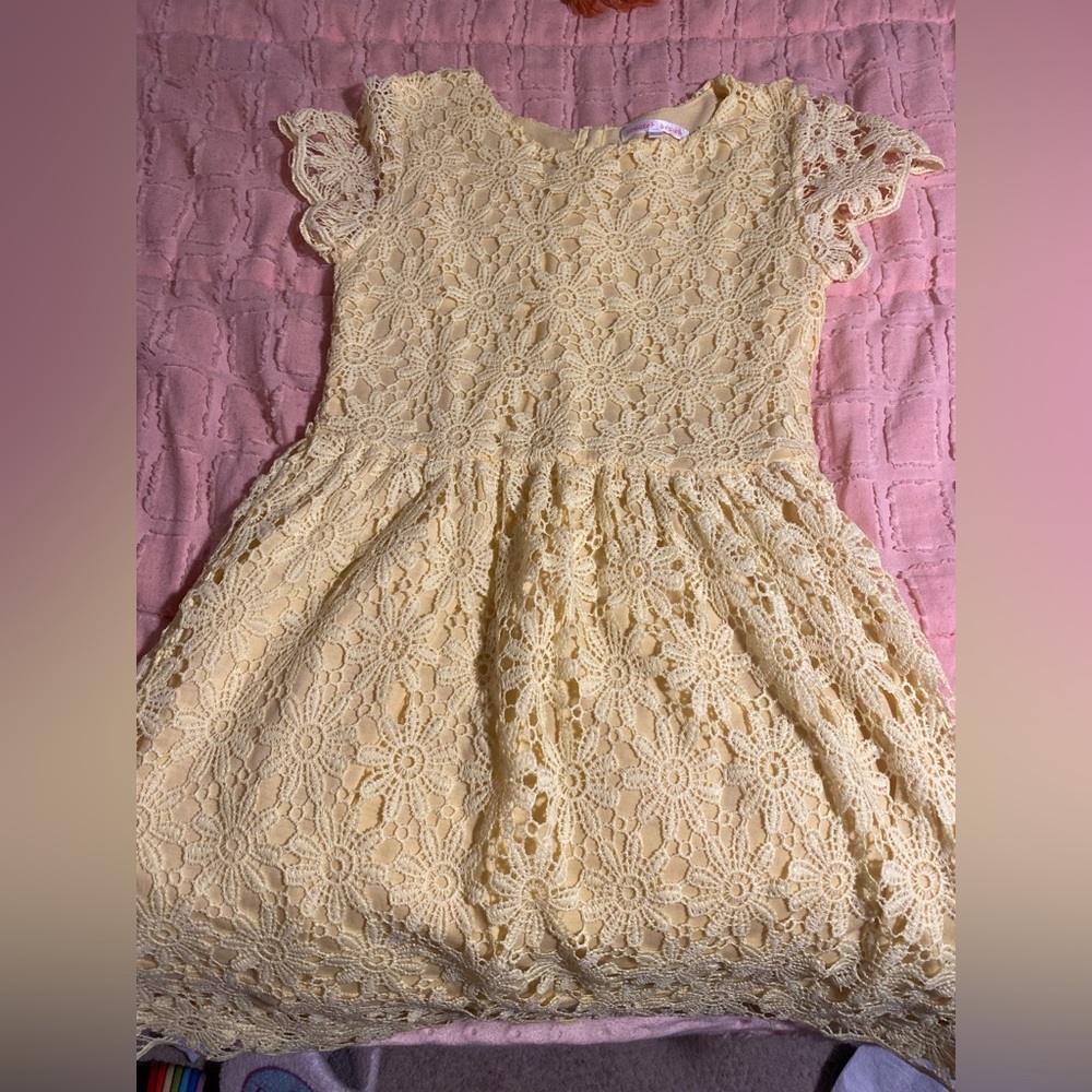 A yellow scooter brown dress with flower print. Never been worn. No stains.